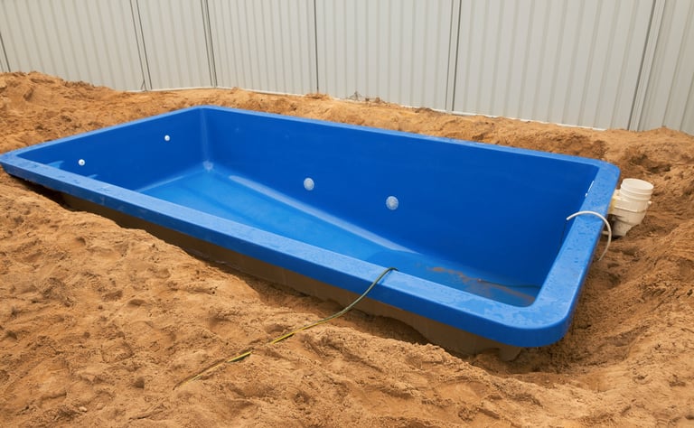 Fiberglass pool installation in backyard