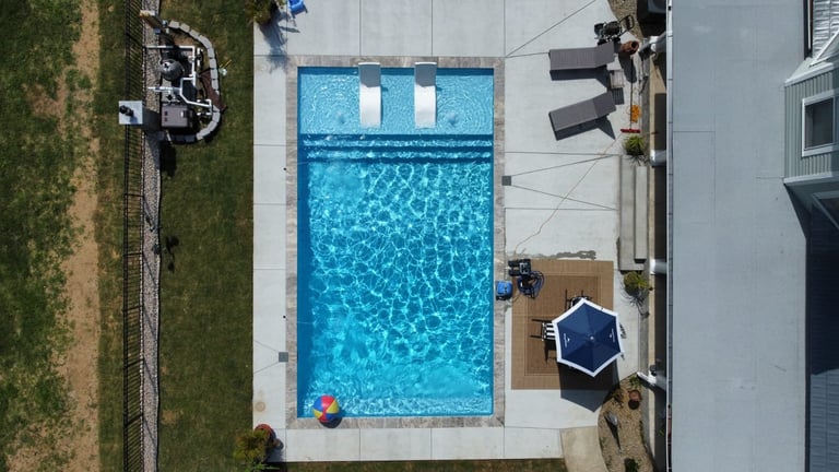 Overhead view of residential swimming pool with blue water and lane dividers